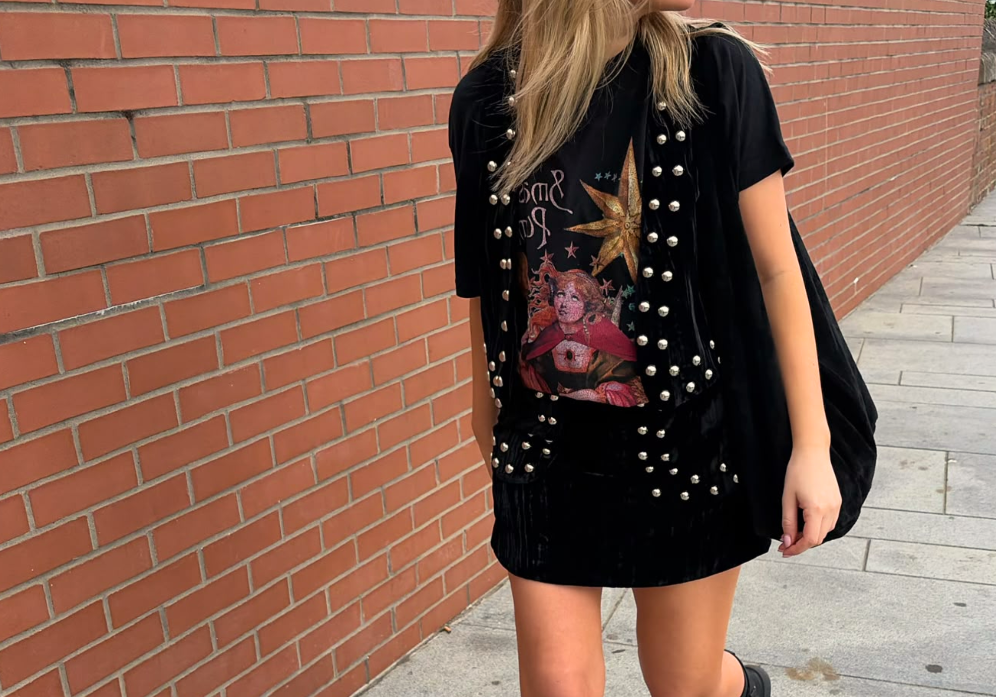 Model wearing Little Lies The Smashing Pumpkins celestial band tee styled with Lennon studded velvet waistcoat and matching mini skirt in black for vintage-inspired rock and boho styling
